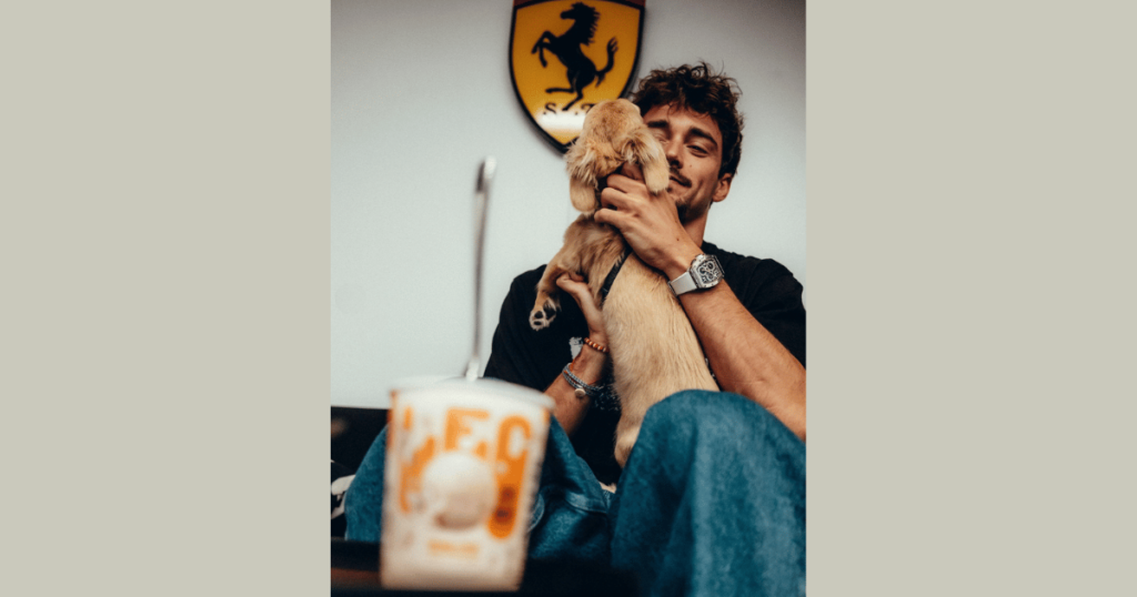 Charles Leclerc Playing with his dog Leo with Lec the icecream cup in background.